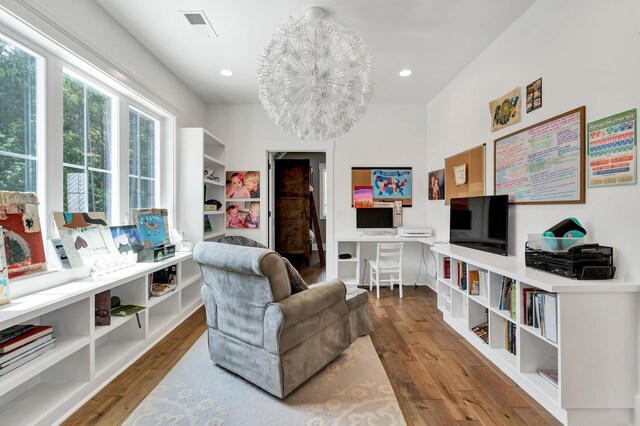 sitting room featuring a chandelier and hardwood / wood-style floors