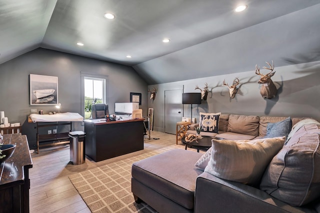 living room with light hardwood / wood-style floors and lofted ceiling