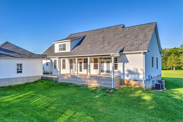 rear view of house with covered porch, french doors, and a yard