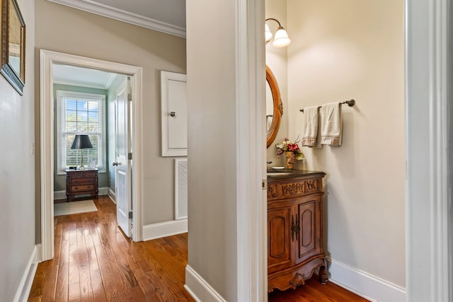 corridor featuring hardwood / wood-style floors and crown molding