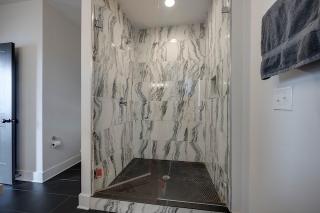 bathroom with a shower with shower door and tile patterned flooring