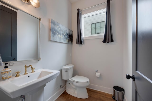 bathroom with wood-type flooring, sink, and toilet