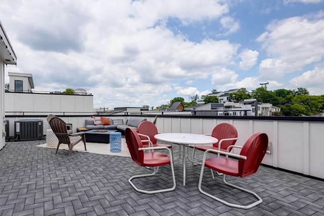 view of patio / terrace featuring an outdoor living space with a fire pit and central air condition unit