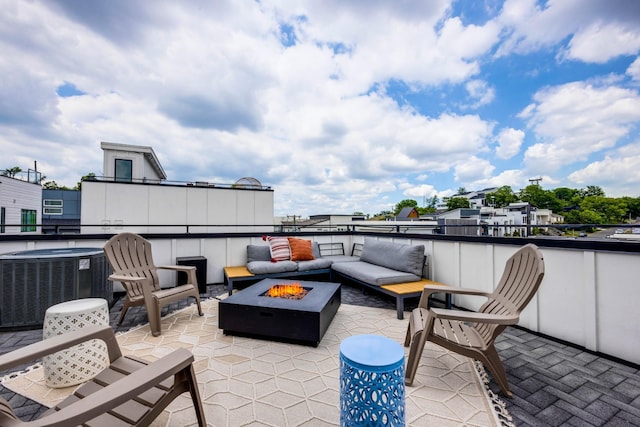 view of patio with central AC and an outdoor living space with a fire pit