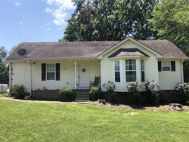 ranch-style home featuring a front lawn, covered porch, roof with shingles, and crawl space