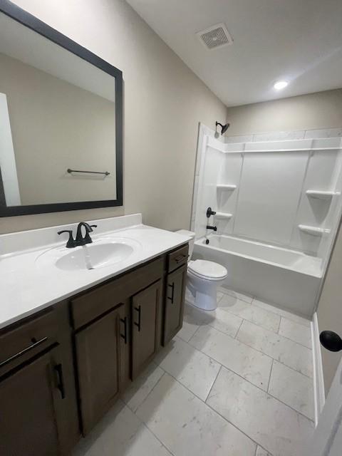 full bathroom featuring vanity,  shower combination, and toilet