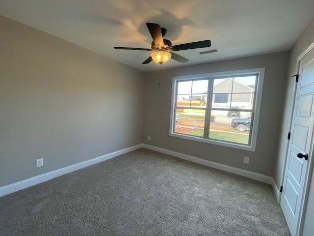 interior space featuring carpet floors and ceiling fan