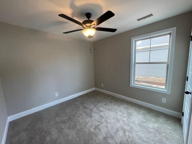 empty room with carpet flooring and ceiling fan