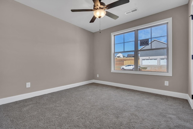 spare room featuring ceiling fan, carpet floors, visible vents, and baseboards