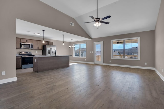 unfurnished living room featuring baseboards, visible vents, dark wood finished floors, vaulted ceiling, and ceiling fan with notable chandelier