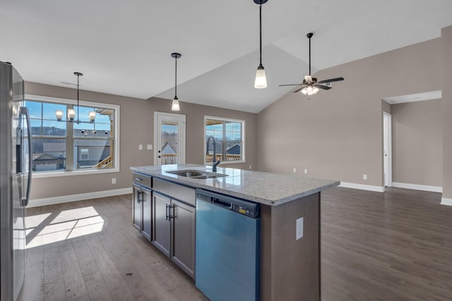 kitchen featuring hanging light fixtures, dark wood-type flooring, a sink, stainless steel fridge, and dishwashing machine