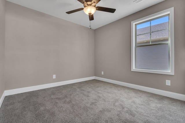 spare room featuring ceiling fan, visible vents, baseboards, and carpet flooring