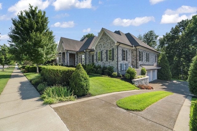 view of front of home with a garage and a front yard