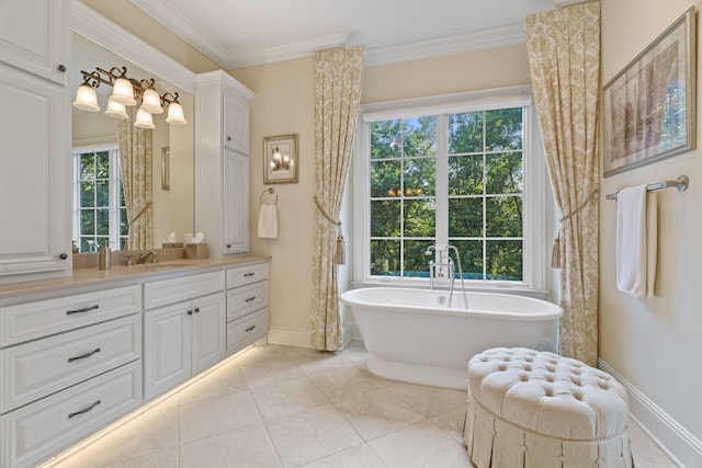 bathroom featuring a washtub, plenty of natural light, tile flooring, and vanity