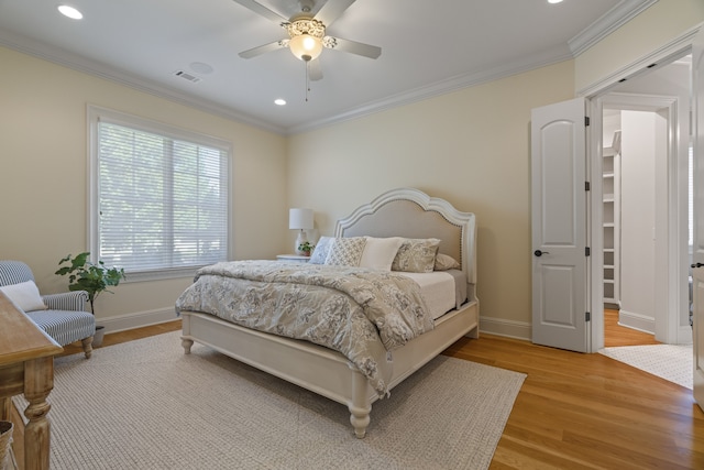 bedroom featuring ceiling fan, hardwood / wood-style floors, and ornamental molding