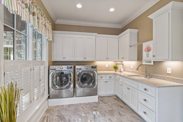 laundry room featuring cabinets, washing machine and clothes dryer, ornamental molding, sink, and light tile floors