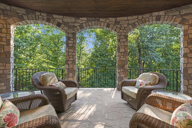 view of patio with an outdoor living space and a balcony