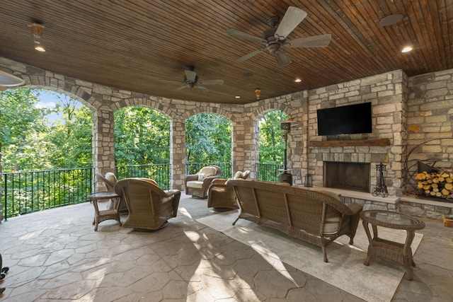 view of terrace featuring an outdoor living space with a fireplace and ceiling fan