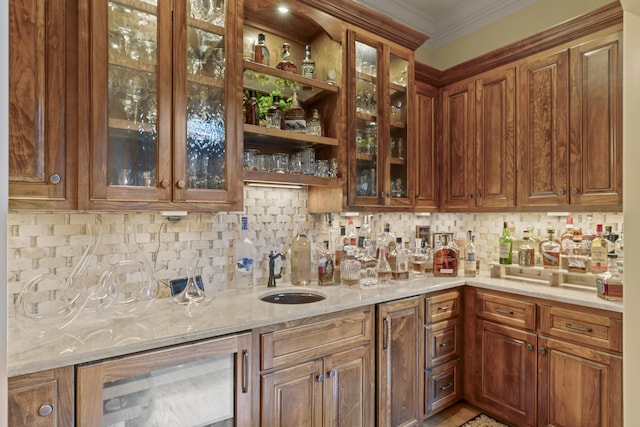 interior space with backsplash, sink, light stone countertops, and beverage cooler