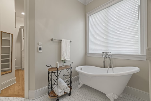 bathroom with tile floors, plenty of natural light, and ornamental molding