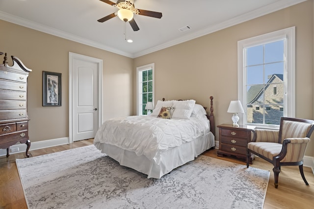 bedroom featuring crown molding, wood-type flooring, and ceiling fan