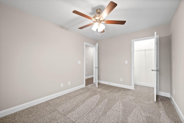 unfurnished bedroom with ceiling fan and carpet floors