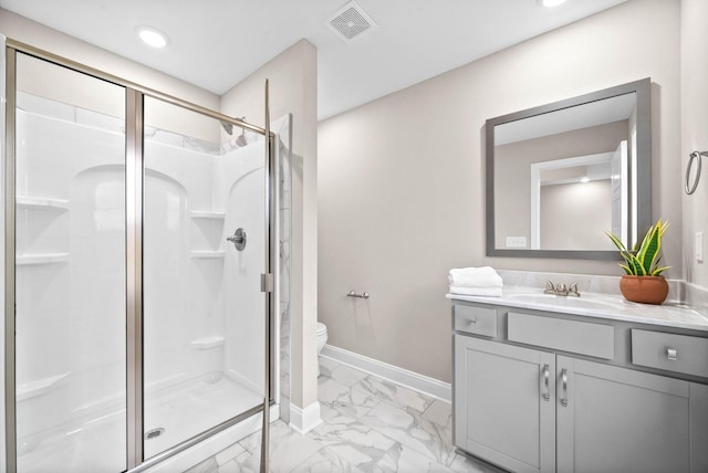 bathroom featuring vanity, an enclosed shower, and toilet