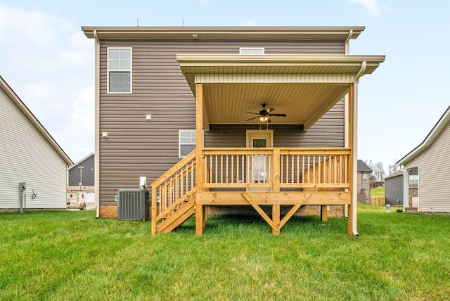 rear view of property with a yard, central AC unit, ceiling fan, and a deck