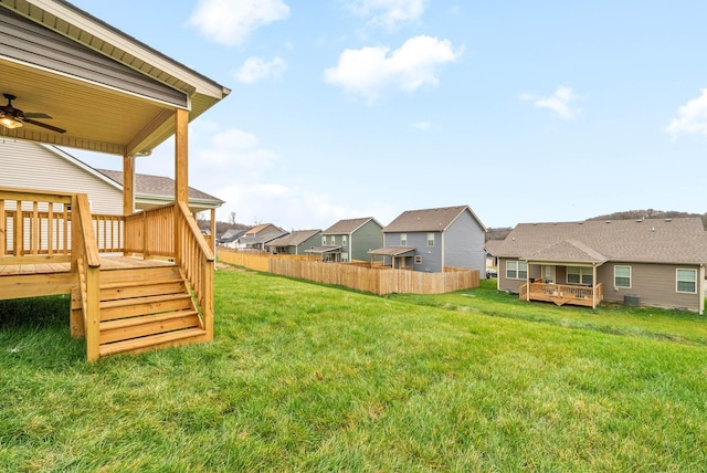 view of yard with ceiling fan and a wooden deck