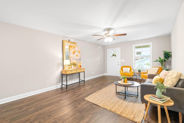 living room with ceiling fan and dark wood-type flooring