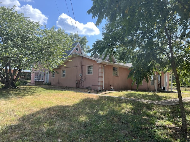 view of property exterior with a lawn