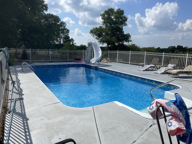 view of pool featuring a patio and a water slide