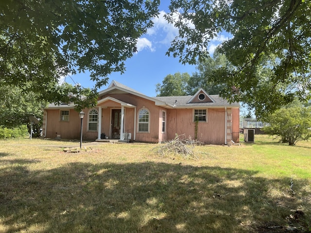 rear view of house with a yard