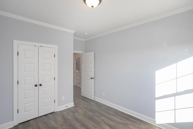 unfurnished bedroom with dark hardwood / wood-style flooring, a closet, and ornamental molding