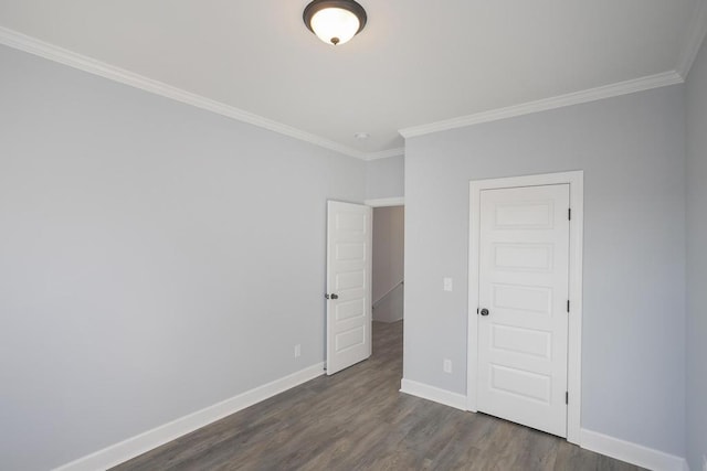 spare room with dark hardwood / wood-style flooring and ornamental molding