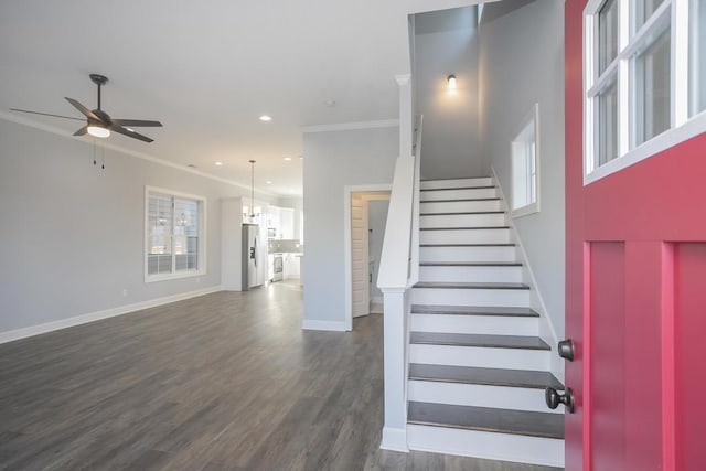 staircase with wood-type flooring, ceiling fan, and crown molding