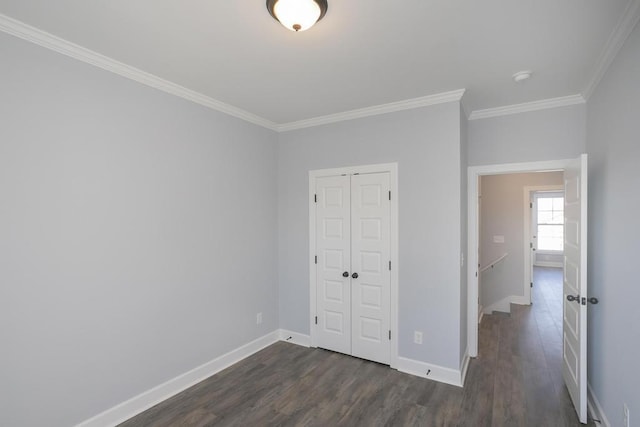 unfurnished bedroom with dark hardwood / wood-style floors, a closet, and crown molding