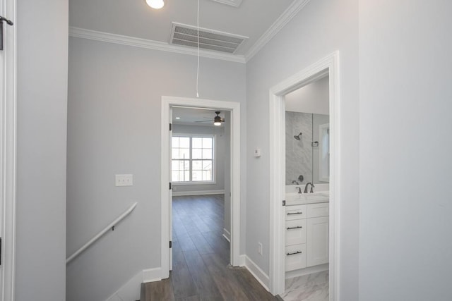 hall featuring dark wood-type flooring and ornamental molding