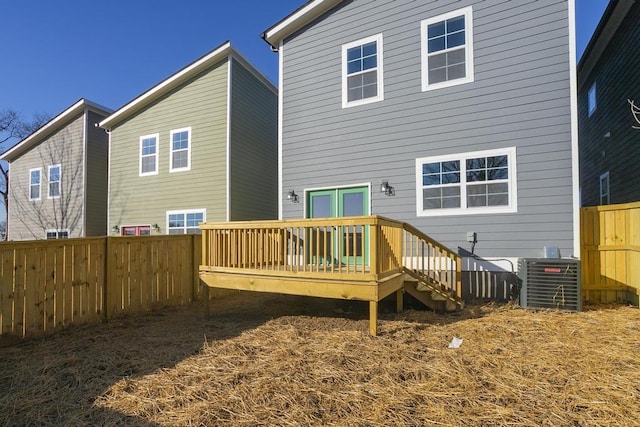 back of property featuring a deck and central air condition unit