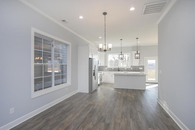 kitchen with dark hardwood / wood-style flooring, backsplash, decorative light fixtures, white cabinets, and a center island