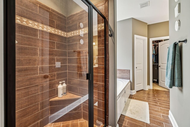 bathroom featuring separate shower and tub