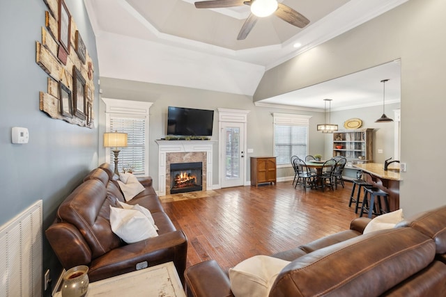 living room with hardwood / wood-style floors, ceiling fan, and crown molding