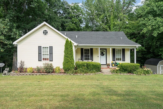 ranch-style house featuring a front yard, a storage unit, and covered porch