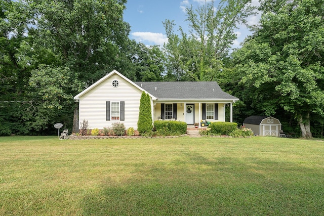 ranch-style house featuring a shed, covered porch, and a front yard