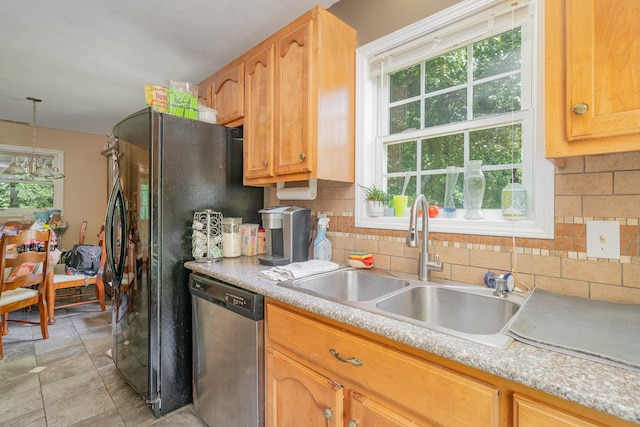 kitchen featuring pendant lighting, sink, stainless steel dishwasher, and plenty of natural light