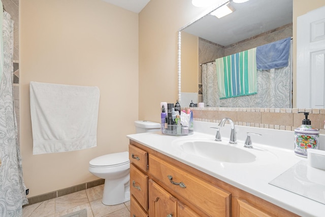 bathroom with tile patterned floors, vanity, and toilet