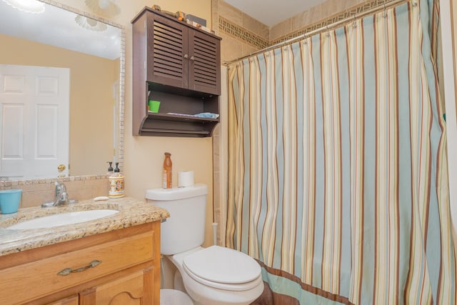 bathroom featuring vanity, toilet, and walk in shower