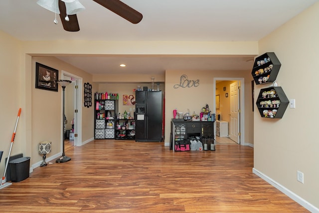 miscellaneous room with wood-type flooring and ceiling fan