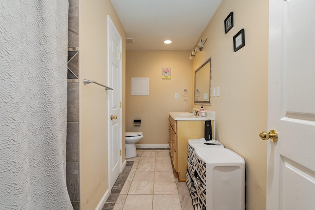 bathroom with tile patterned floors, vanity, and toilet