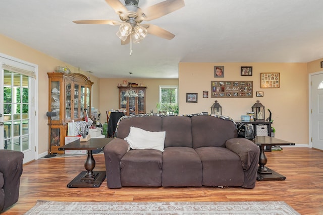 living room featuring light wood-type flooring, plenty of natural light, and ceiling fan